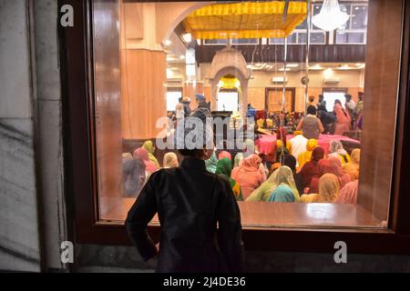 Srinagar, India. 14th Apr, 2022. A young Sikh devotee looks on as devotees pray inside a Gurdwara or a Sikh temple on the occasion of Baisakhi in Srinagar, Kashmir.Baisakhi, marks the Sikh New Year and is also celebrated as harvest festival in many northern states of India. (Photo by Saqib Majeed/SOPA Images/Sipa USA) Credit: Sipa USA/Alamy Live News Stock Photo