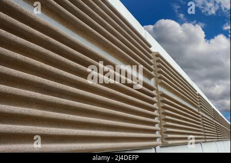 A modern soundproof wall with cloudy sky in background Stock Photo