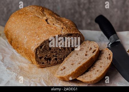 Fresh homemade sourdough bread on a rustic background with copy space Stock Photo