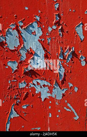 Damaged red metallic surface with peeling paint Stock Photo