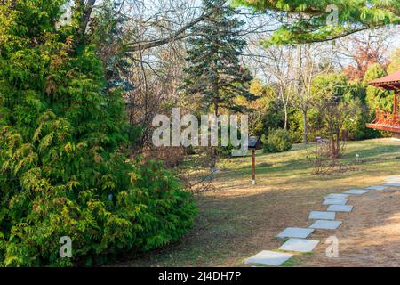 A narrow alley in the Botanic Garden Iasi during autumn, Romania Stock Photo