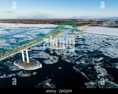 Laviolette Bridge, during winter, crossing the St. Lawrence River and ice floe in Trois-Rivieres, Quebec, Canada Stock Photo