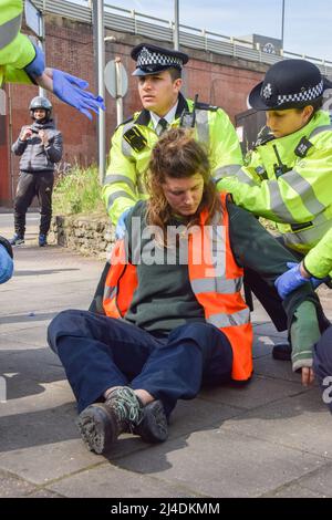 London, England, UK. 14th Apr, 2022. Police arrest a protester who was on top of the oil tanker. Just Stop Oil activists glued themselves to the top of an oil tanker and blocked the traffic on Chiswick Roundabout in West London in protest against fossil fuels. The group aims to disrupt the flow of oil in the capital. (Credit Image: © Vuk Valcic/ZUMA Press Wire) Credit: ZUMA Press, Inc./Alamy Live News Stock Photo