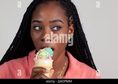 Young Black woman enjoying an ice cream cone Stock Photo