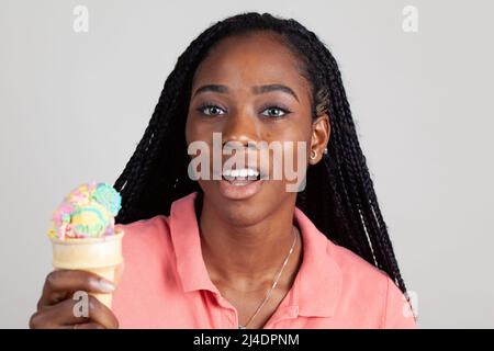 Young Black woman enjoying an ice cream cone Stock Photo