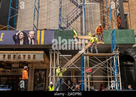 Workers construct scaffolding over the Manhattan Theatre ClubÕs Samuel J, Friedman Theatre where ÒHow I Learned To DriveÓ is being performed on a dark Monday, April 4, 2022.  (© Richard B. Levine) Stock Photo