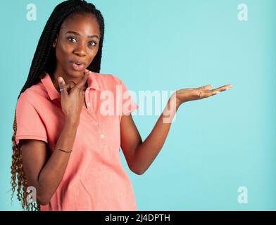 African American woman with upturned palm. Spokesperson pose holding your product in the palm of her hand. Stock Photo