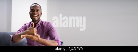 African American Deaf Man Using Sign Language Stock Photo