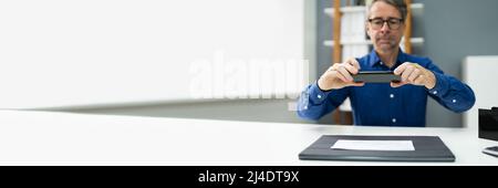 Remote Check Deposit Using Mobile Photo. Scanning Documents With Phone Stock Photo