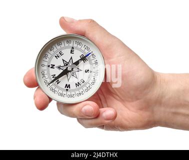 Hand holding traditional magnetic compass, vintage retro style, isolated on white background Stock Photo