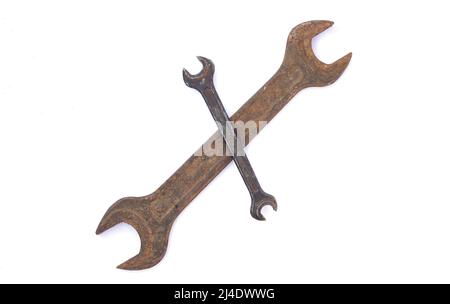 Two old rusty crossed wrenches isolated on white background Stock Photo