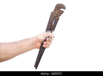 Plumber holding large old pipe wrench isolated on white background Stock Photo