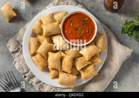 Homemade Microwaved Frozen Pizza Rolls with Marinara Sauce Stock Photo