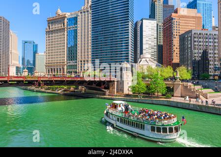 CHICAGO, ILLINOIS, USA - MAY 16, 2018: Passengers enjoy a riverboat cruise through downtown Chicago.