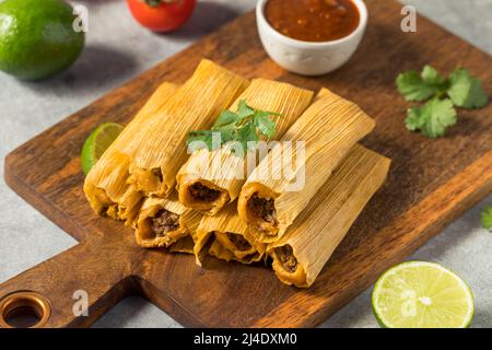 Homemade Beef Cornmeal Tamales with Salsa and Crema Stock Photo