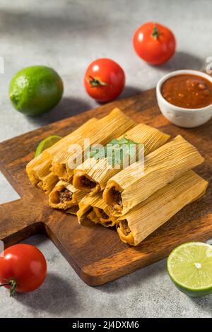 Homemade Beef Cornmeal Tamales with Salsa and Crema Stock Photo