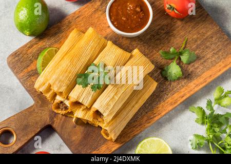 Homemade Beef Cornmeal Tamales with Salsa and Crema Stock Photo