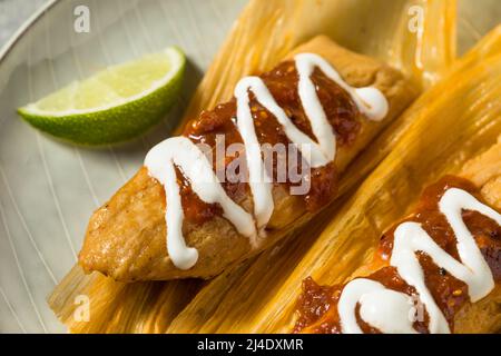 Homemade Beef Cornmeal Tamales with Salsa and Crema Stock Photo