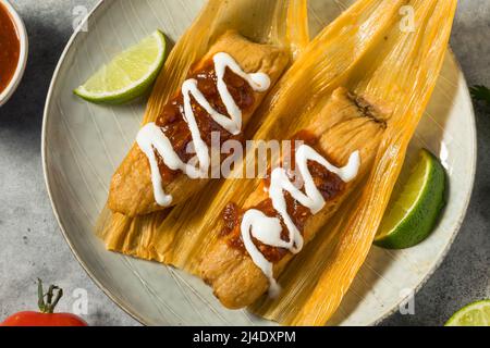 Homemade Beef Cornmeal Tamales with Salsa and Crema Stock Photo