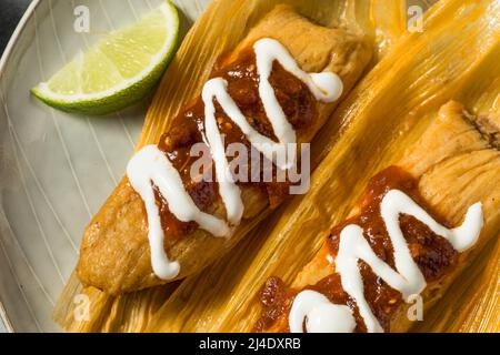 Homemade Beef Cornmeal Tamales with Salsa and Crema Stock Photo