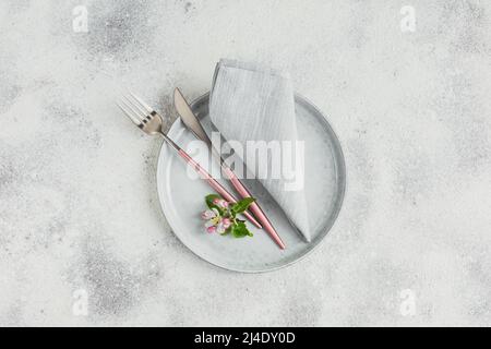 Place table setting with blossoming apple tree branches and flowers Stock Photo