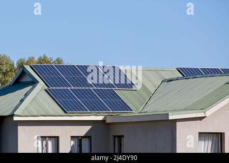 Solar panels on green domestic house roof Stock Photo