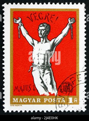 HUNGARY - CIRCA 1969: a stamp printed in the Hungary shows Man Breaking Chains, Revolutionary Poster, circa 1969 Stock Photo