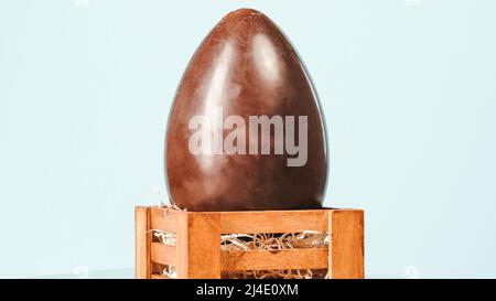 Easter chocolate egg on blue background. Easter Holiday Stock Photo