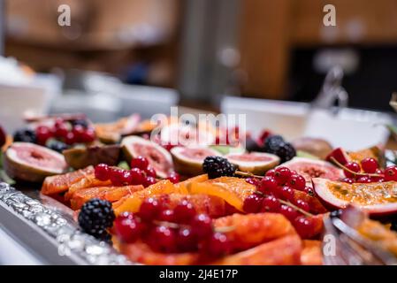 Various healthy fruits served in plate on counter at luxurious hotel Stock Photo