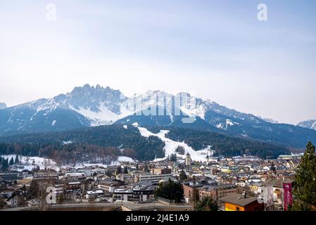 Idyllic view of beautiful townscape and majestic mountains against sky Stock Photo