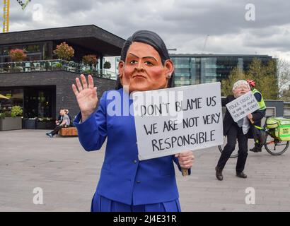 London, UK, 14th April 2022. Protesters wearing Priti Patel and Boris Johnson masks in Granary Square. Extinction Rebellion activists held an 'outreach day' in King's Cross, engaging with the public and demanding that the government acts on the ecological and climate crisis. Credit: Vuk Valcic/Alamy Live News Stock Photo