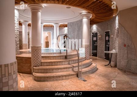 Elegant round jacuzzi in modern bathroom in luxurious ski resort Stock Photo