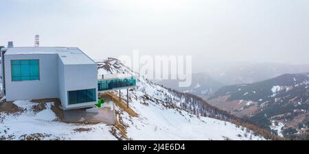 Modern alpine museum and restaurant on snowy mountain against sky in alps Stock Photo