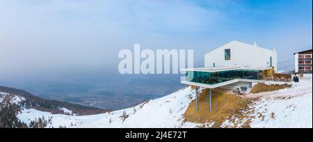 Beautiful alpine restaurant and museum on mountain against sky during winter Stock Photo
