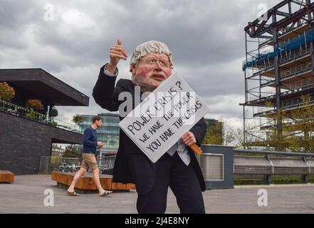 London, England, UK. 14th Apr, 2022. A protester wears a Boris Johnson mask in Granary Square. Extinction Rebellion activists held an 'outreach day' in King's Cross, engaging with the public and demanding that the government acts on the ecological and climate crisis. (Credit Image: © Vuk Valcic/ZUMA Press Wire) Credit: ZUMA Press, Inc./Alamy Live News Stock Photo