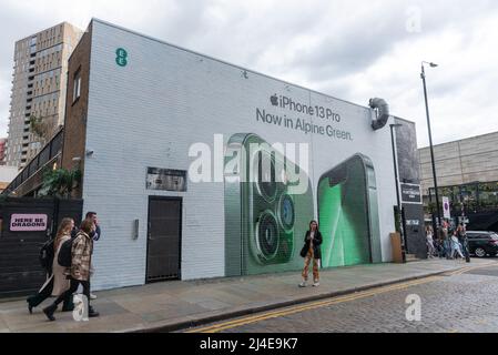 14/04/2022. London, UK. Photo by Ray Tang. A new Apple Pro 13 mural has been painted and unveiled in Shoreditch, East London today. The mural by EE mobile phone network features the new Alpine Green colour phone variant. Stock Photo
