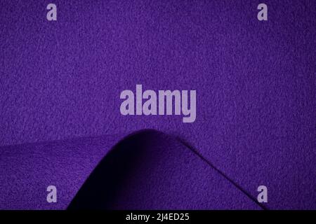 Abstract purple geometric felt texture background. Creative geometric curved felt textile background with copy space. Top view Stock Photo
