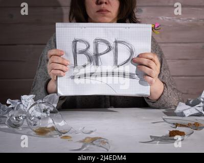 Concept of borderline personality disorder. The abbreviation for BPD is expressively written in pencil with strong pressure on paper. There is crumple Stock Photo