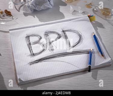 Concept of borderline personality disorder. The abbreviation for BPD is expressively written in pencil with strong pressure on paper. There is crumple Stock Photo