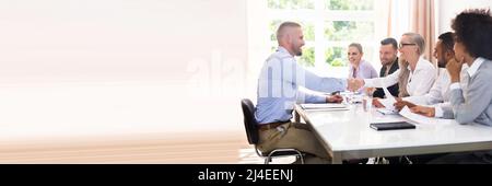 Smiling Young Man Shaking Hands With Female At Interview Stock Photo