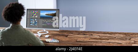Young Male Editor Editing Video On Computer At Workplace Stock Photo