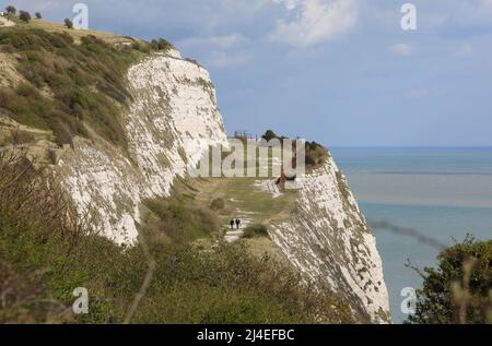 Walking the footpath along the top of the white cliffs of Dover, in spring sunshine, SE Kent, UK Stock Photo