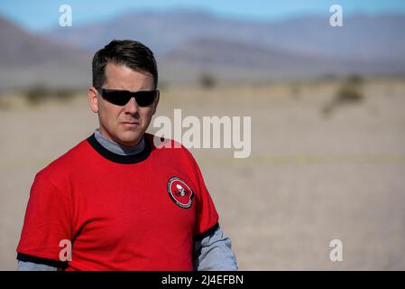 U.S. Air Force Capt. John Walton, 2016 Air Force Research Laboratory Commanders Challenge program execution officer, walks across the test range between scenarios at the Nevada National Security Site, Las Vegas, NV., Dec. 13, 2016. The challenge consisted of six teams who were given six months to develop a complete counter-unmanned aerial system to aid in base defense. (U.S. Air Force photo by Wesley Farnsworth) Stock Photo