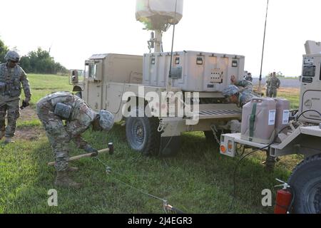 Counter Mortar Radar  - New York Army National Guard Soldiers with the 27th Infantry Brigade Combat Team set up the AN/TPQ-50 Lightweight Counter Mortar Radar (LCMR) on July 31, 2019, at Fort Drum, New York. The radar section for the 27th Infantry Brigade Combat Team took a course on the new radar system that was over a week long before testing in the field.( U.S. Army National Guard photo by Sgt. Andrew Winchell ) Counter rocket, artillery, and mortar, abbreviated C-RAM or counter-RAM, is a set of systems used to detect and/or destroy incoming rockets, artillery, and mortar rounds in the air. Stock Photo