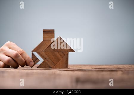 Miniature House Puzzle Pieces And Tangram. Wooden Toy Real Estate Stock Photo