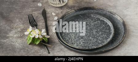 Plase table setting with blossoming apple tree branches and flowers Stock Photo