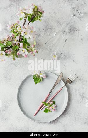 Plase table setting with blossoming apple tree branches and flowers Stock Photo