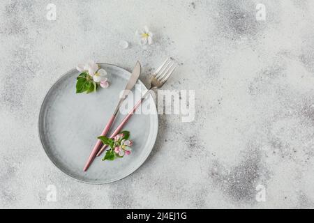 Plase table setting with blossoming apple tree branches and flowers Stock Photo