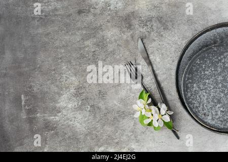 Plase table setting with blossoming apple tree branches and flowers Stock Photo