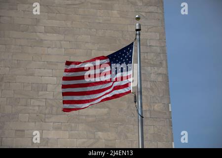 United States Flag Waving in front of the Washington Monument Stock Photo